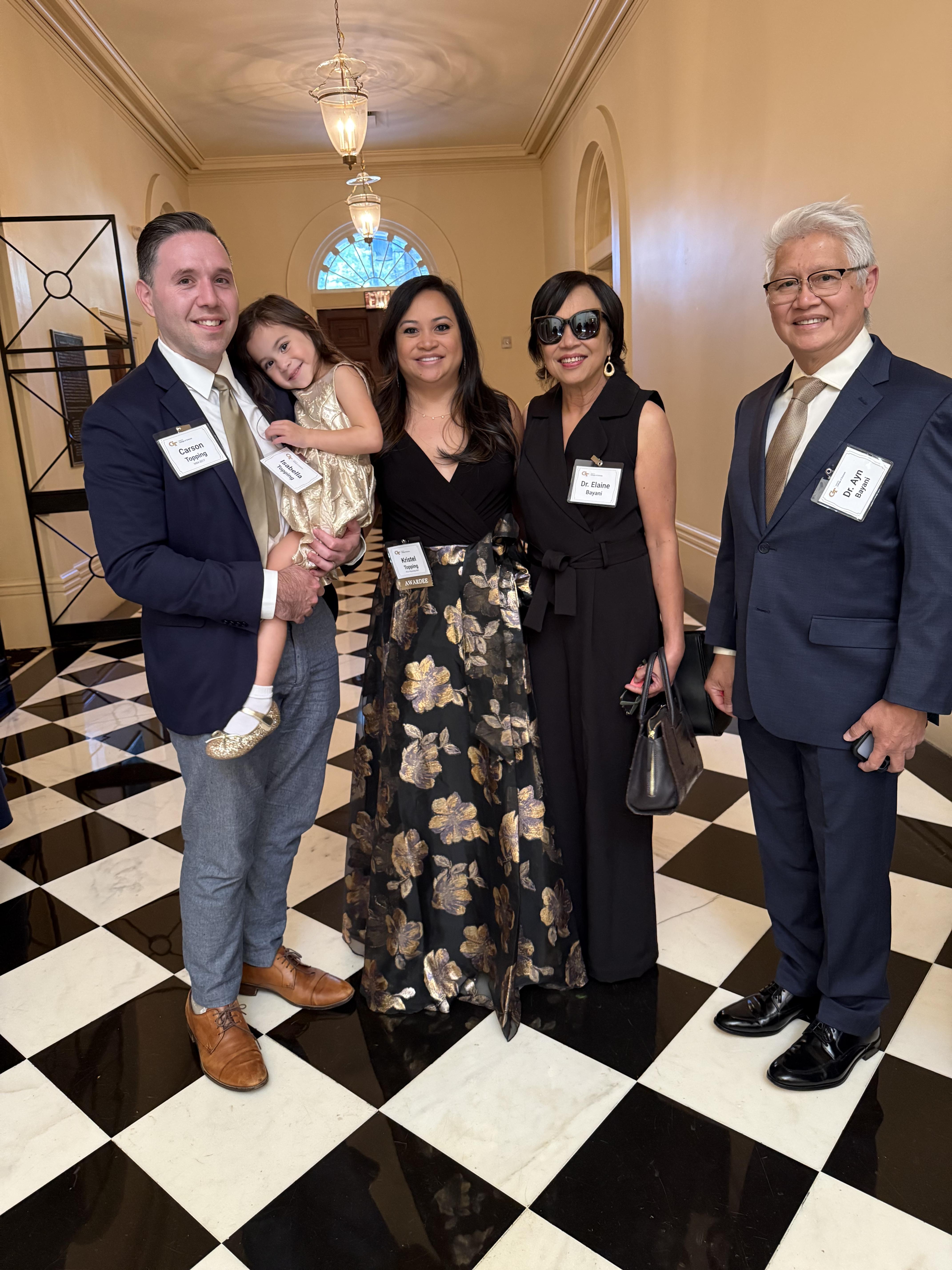 A family group standing in a hallway