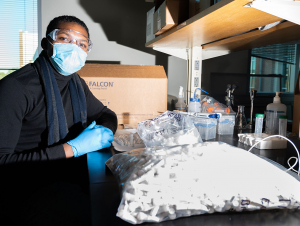 A staff member assembles kits for campus Covid-19 surveillance testing