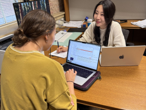 Eunbee Kim provides personalized statistical guidance to a student during a recent Stats HelpDesk session. A student and woman confer at a desk.
