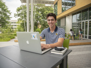 Student outside the Kendeda Building