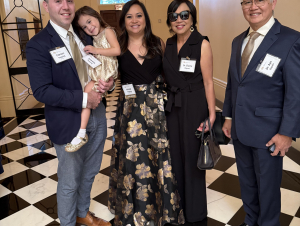 Three generations celebrated Kristel Bayani Topping's award. A family group standing in a hallway